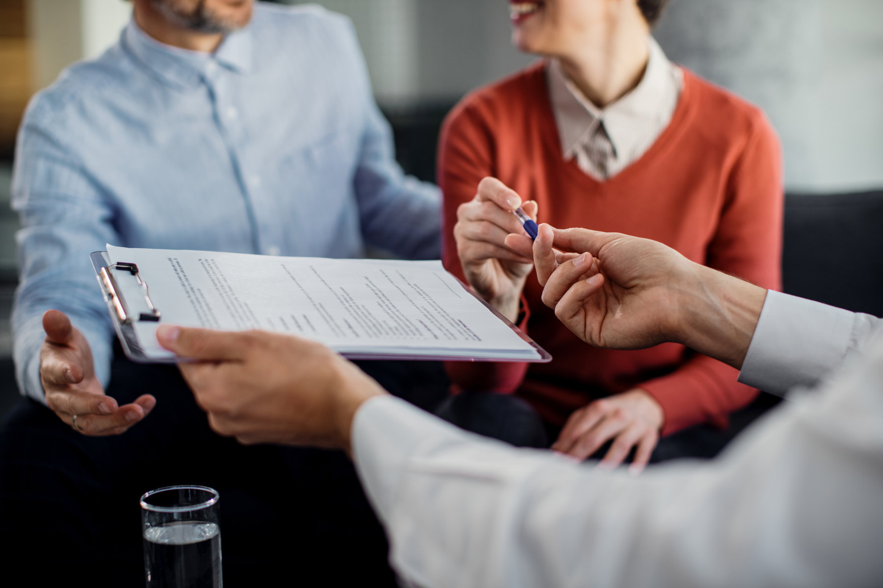 closeup unrecognizable couple signing contract with financial advisor (fileminimizer)